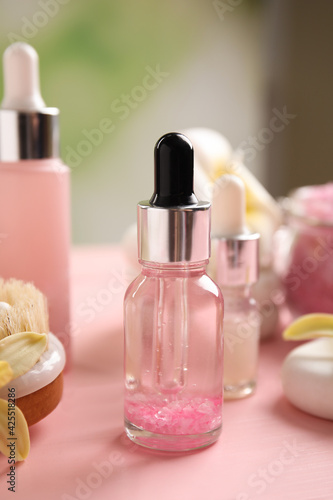 Composition with spa cosmetic on pink wooden table  closeup