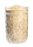 Glass jar with quinoa on white background