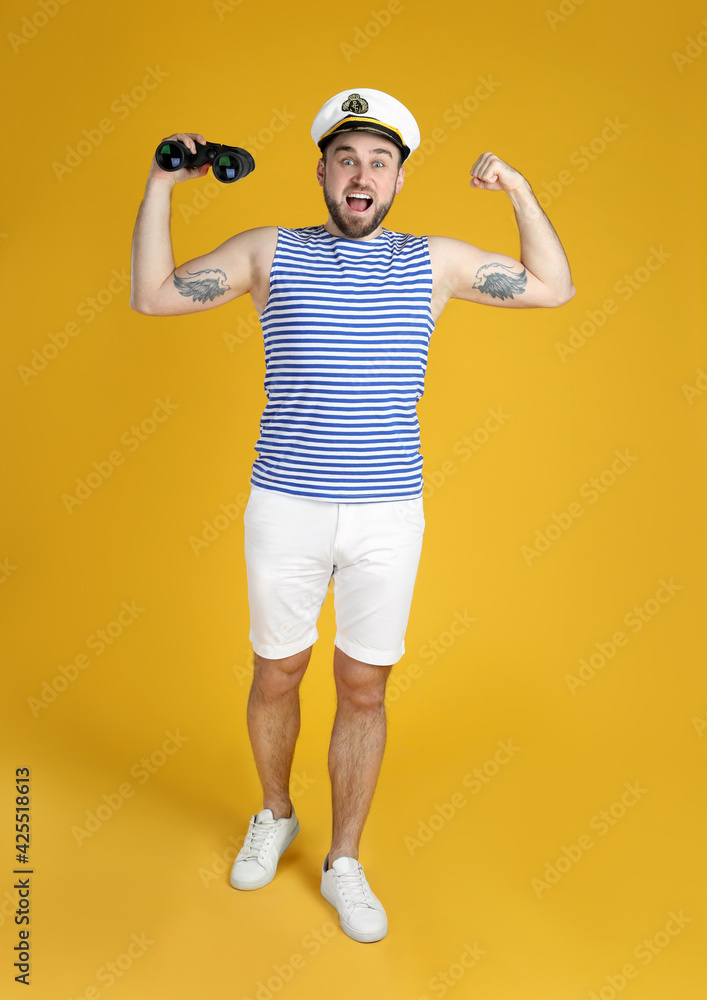 Emotional sailor with binoculars on yellow background Emotional sailor with binoculars on yellow background