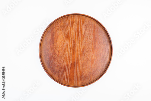 A round wooden tray on white background