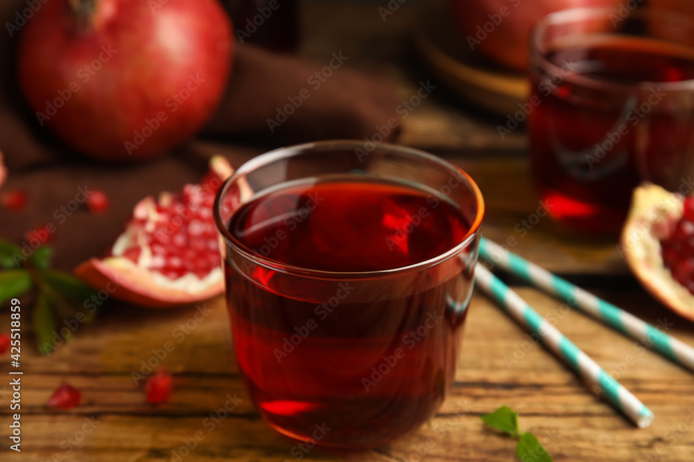 Delicious pomegranate juice and fresh fruits on wooden table Delicious pomegranate juice and fresh fruits on wooden table
