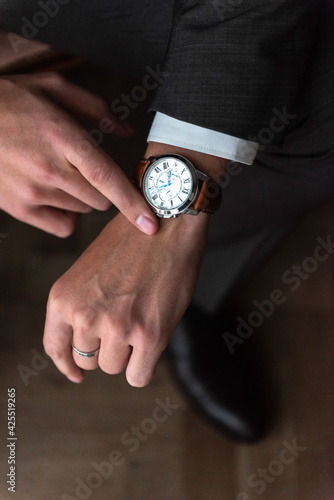 Men's accessories, butterfly on the neck, watch on the hands, men's shoes. Groom.
