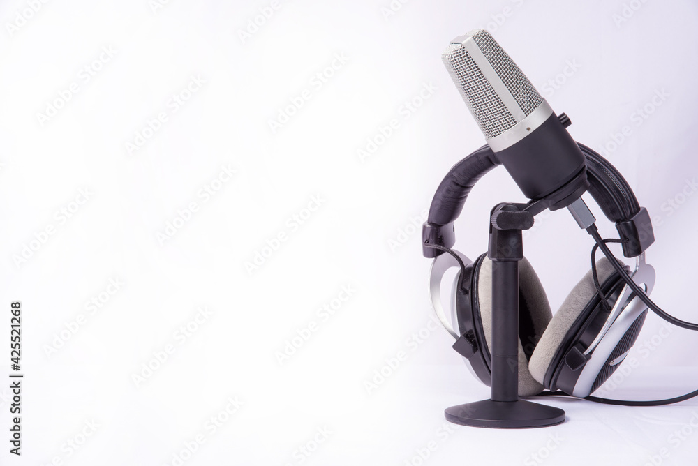 home work, professional condenser microphone and headphones on white background, high key portrait, selective focus.