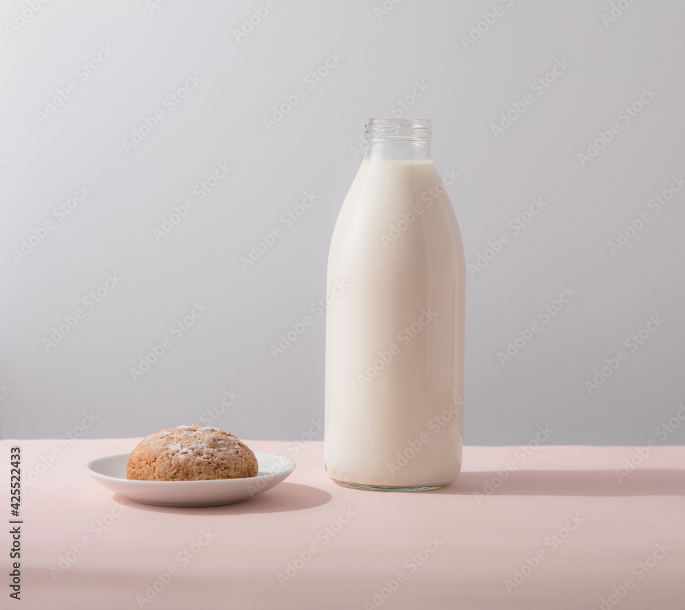 Oatmeal cookies and milk in bottle, healthy snack. Light background Oatmeal cookies and milk in bottle, healthy snack. Light background