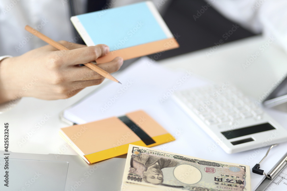 Businessman Calculating Finance At Desk Businessman Calculating Finance At Desk