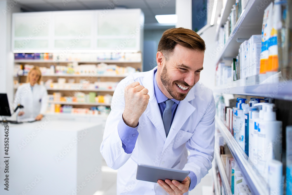 Pharmacist checking medics inventory on tablet computer in pharmacy store.