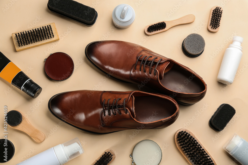 Flat lay composition with shoe care accessories and footwear on beige background Flat lay composition with shoe care accessories and footwear on beige background