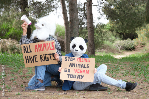 Fotografi Activist protesters wearing animal masks shouting through a bullhorn to highlight cruelty and promote vegan lifestyle