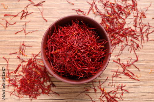 Dried saffron on wooden table, flat lay