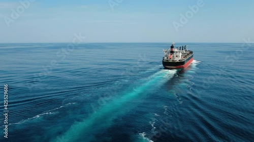 Large cargo ship. A bulk carrier carries cargo across the ocean. Transportation. Delivery. Logistics. A large ship for transporting. Aerial 4k shot.