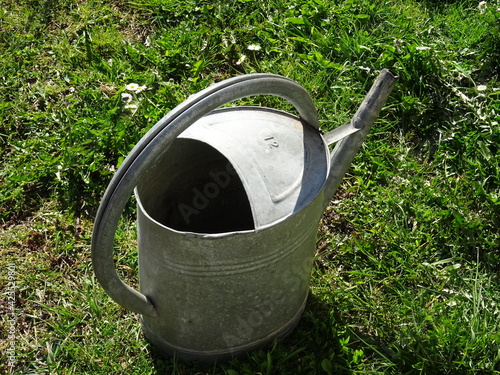 old watering can on grass