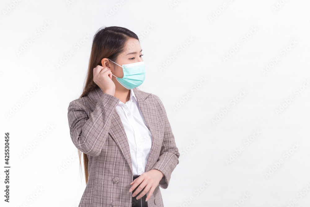Asian business woman wears formal suit and medical face mask to protect infection disease (COVID-19) in healthcare, new normal concept. Asian business woman wears formal suit and medical face mask to protect infection disease (COVID-19) in healthcare, new normal concept.