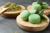 Delicious matcha mochi on grey table, space for text
