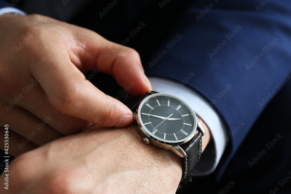 Businessman in jacket with luxury wrist watch, closeup Businessman in jacket with luxury wrist watch, closeup