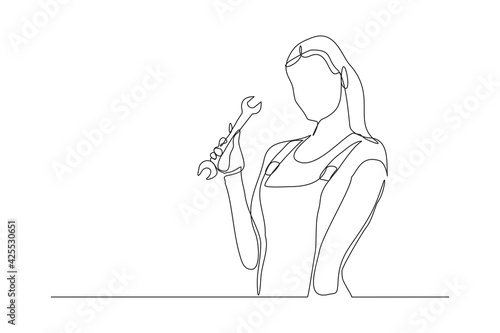 Continuous line drawing of young female mechanic pose holding set of wrench. Single one line art of professional job profession minimalist concept. vector illustration
