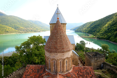 Two of Medieval Churches in Ananuri Fortress Against the Emerald Green Water of Jinvali Reservoir, Georgia photo