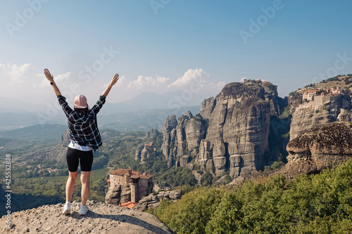 Woman tourist standing with a beautiful view to Meteora , Greece