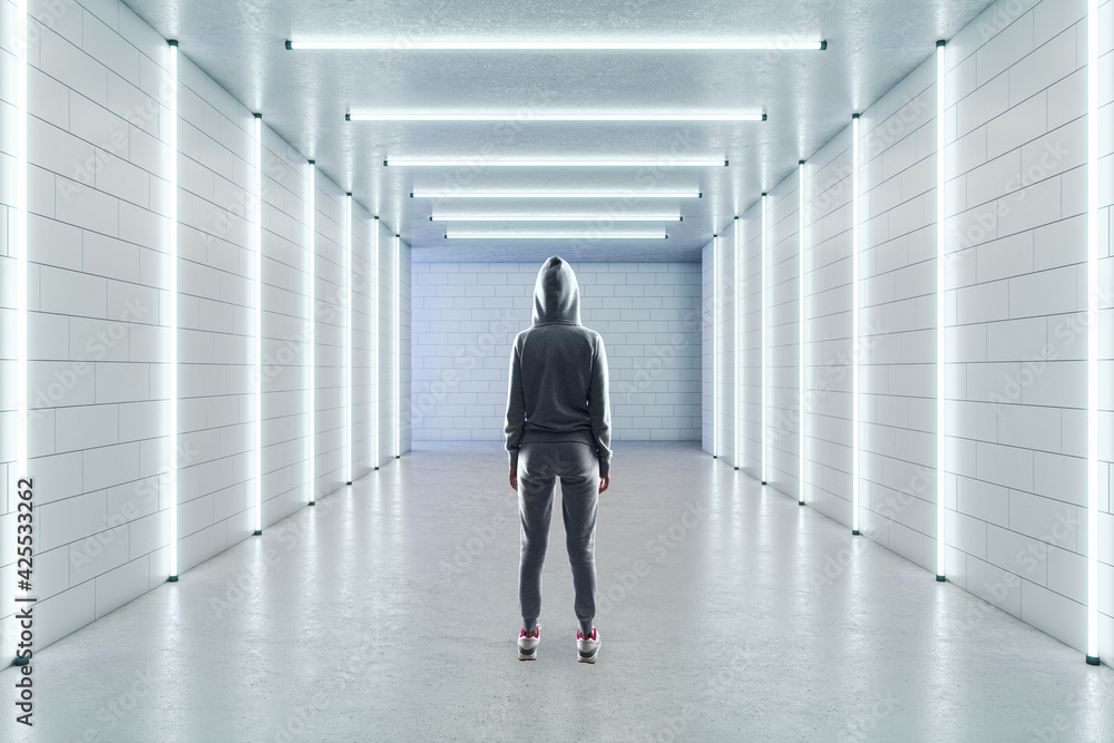 Empty long white gallery with a person standing in the middle, fluorescent lights and a blank white wall in the background, concrete floor and brick walls, interior design and showroom Empty long white gallery with a person standing in the middle, fluorescent lights and a blank white wall in the background, concrete floor and brick walls, interior design and showroom