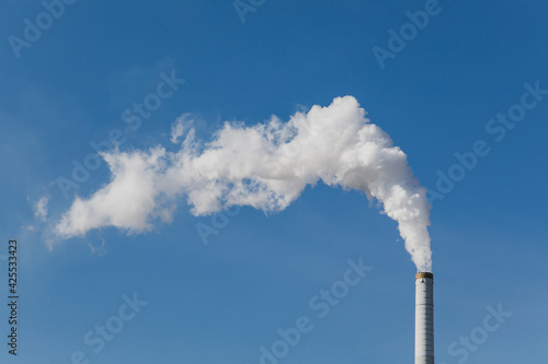 smoke get out of industrial chimney is a symbol for climate change and pollution and shows not reaching temperature goals