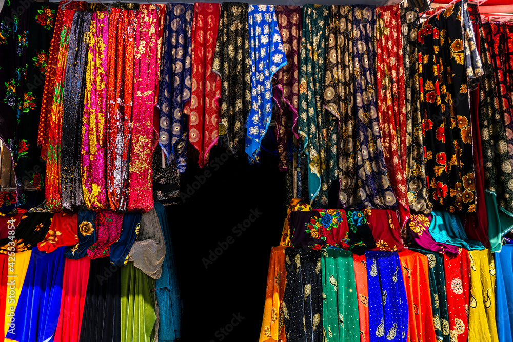Rolls of fabric and textiles in a factory shop. Multi different colors and patterns on the market Fabrics in rolls. Fabric store 