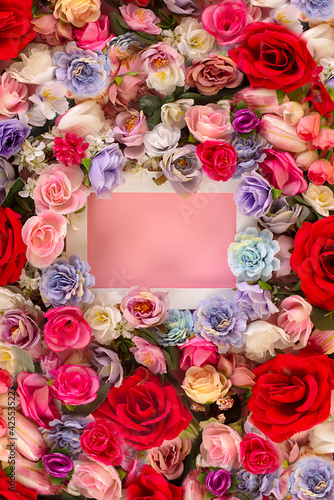 Flowers composition. White flower photo frame on red background. Flat lay, top view, copy space 
