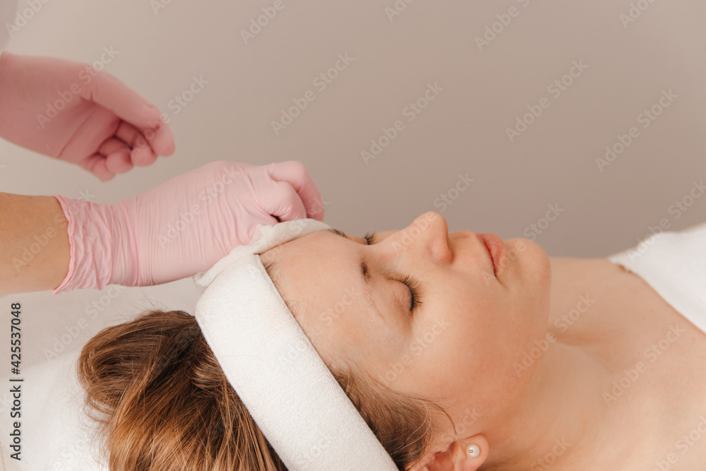 beautician makes cosmetic procedures to the girl beautician makes cosmetic procedures to the girl