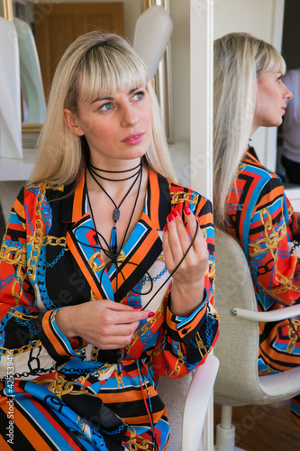 Young elegant stylish blonde. Business Lady. Gemstone jewelry. Makeup room.