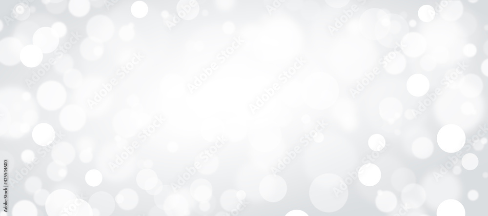 Defocused white lights on a gray background. Abstract bokeh on a white background. Defocused white lights on a gray background. Abstract bokeh on a white background.