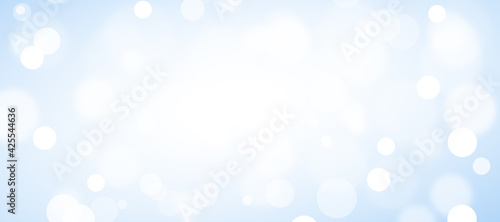 Abstract white bokeh on blue background, background design in sky blue color, sparkles and shimmery background in the shape of a circle.