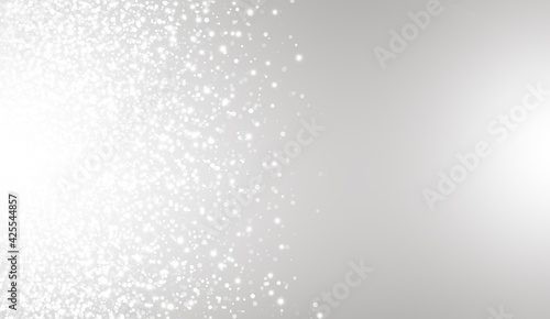 White glitter texture on gray background. Explosion of white confetti. Suitable for wedding invitations, Christmas and greeting cards.