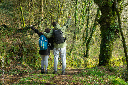 Happy couple walking in the woods. Lifestyle concept, outdoors, hike.