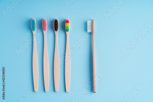 A bunch of eco-friendly bamboo toothbrushes. Global environmental trends. Gender and racial inequality. Toothbrushes of different genders © Kate