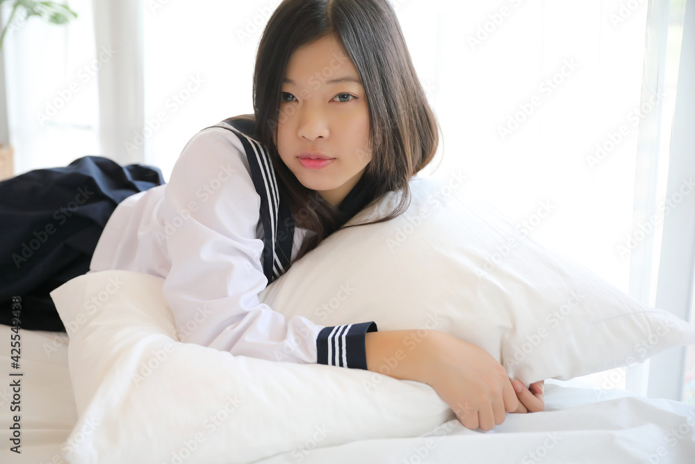 school girl sleeping on bed in white tone bedroom school girl sleeping on bed in white tone bedroom
