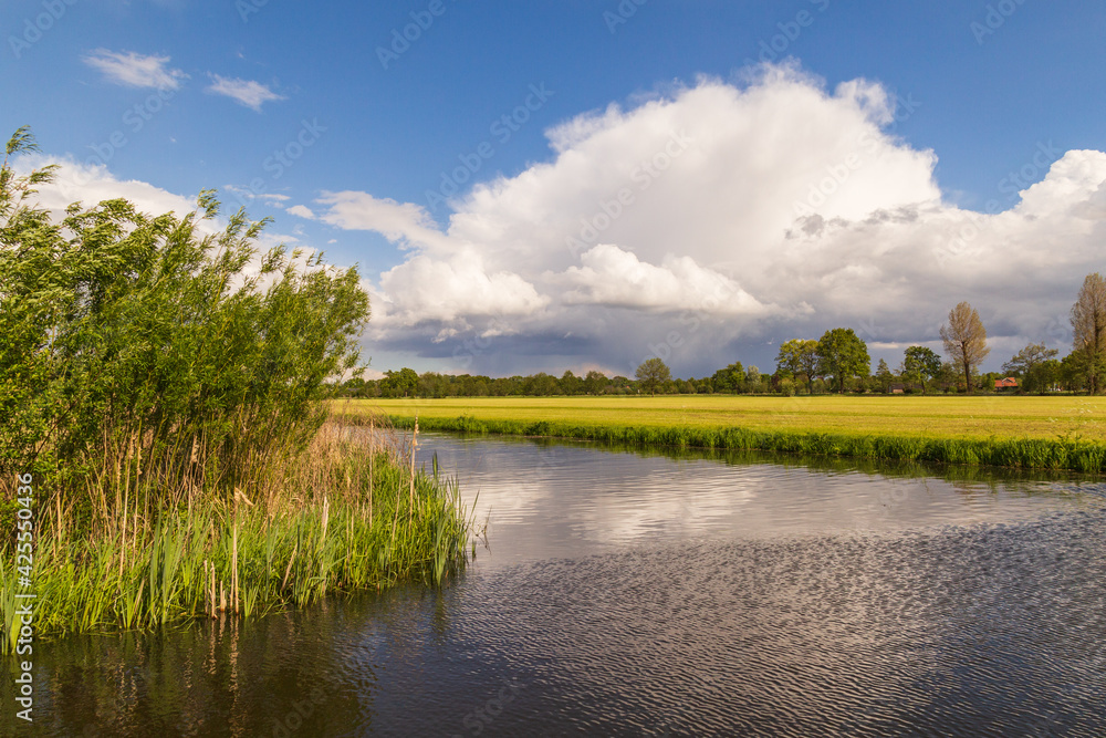 View of the river Barneveldse Beek in the Dutch polder landscape.