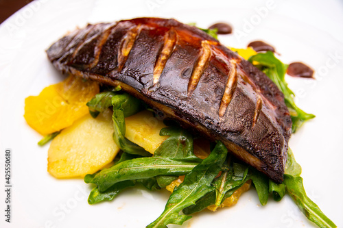 Baked mackerel on a pillow of pineapple and arugula