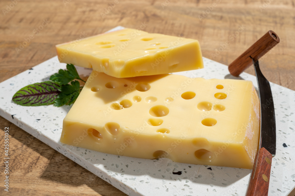 Cheese collection, blocks of French emmentaler cheese with many round holes made from cow milk Cheese collection, blocks of French emmentaler cheese with many round holes made from cow milk