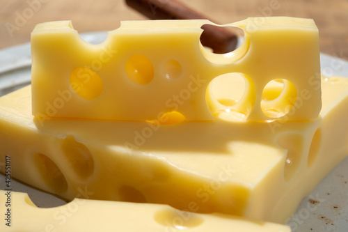 Cheese collection, blocks of French emmentaler cheese with many round holes made from cow milk