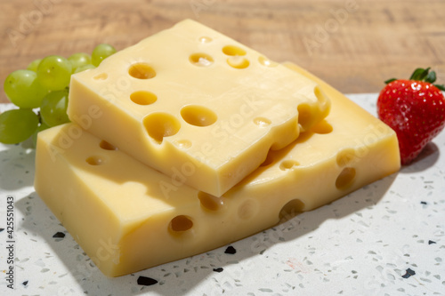 Cheese collection, blocks of French emmentaler cheese with many round holes made from cow milk