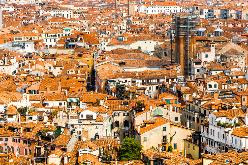 Venice old historical centre with buildings with red tiled roofs, churches and bell tower, Italy