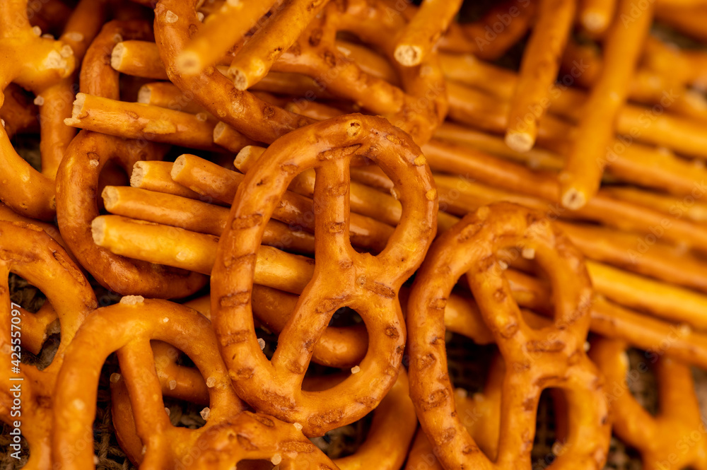 Salted breadsticks and salted pretzels scattered on the table. Salted breadsticks and salted pretzels scattered on the table.