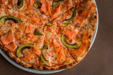 Pizza with salmon and avocado close-up