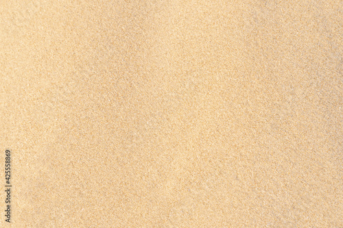 Sand texture background on the beach. Light beige sea sand texture pattern.