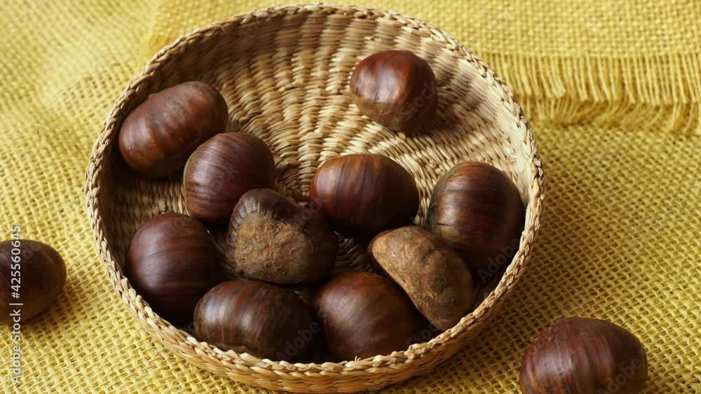 Fresh edible chestnuts in a basket Fresh edible chestnuts in a basket