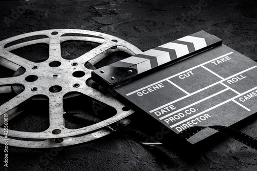 Photo Cinema background with movie clapperboard and film reel