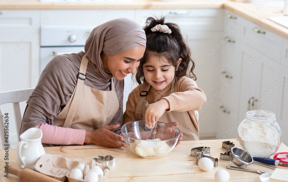Cute Little Arab Girl Helping Her Muslim Mom In Kitchen, Baking ...