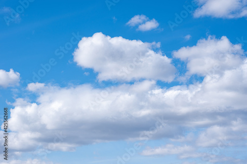 Blue sky with white cumulus clouds. Perfect natural sky background for your photos