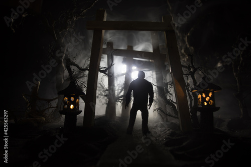 Creative artwork decoration. Abstract Japanese style wooden tunnel at night. Selective focus