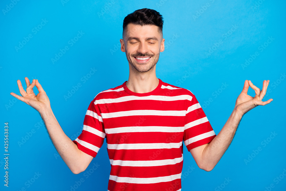 Photo of optimistic nice brunet guy rest closed eyes wear red t-shirt isolated on vivid blue color background Photo of optimistic nice brunet guy rest closed eyes wear red t-shirt isolated on vivid blue color background
