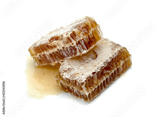 Fresh Honeycomb slice and honey isolated on white background
