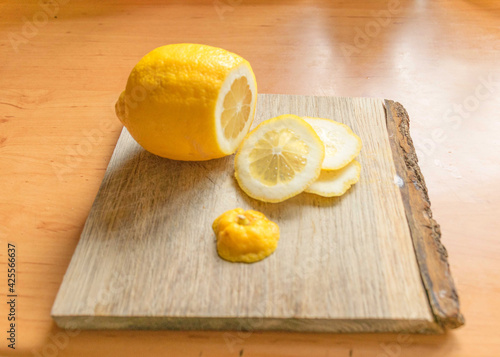sliced lemon slices on a wooden pallet, juicy and fresh lemon